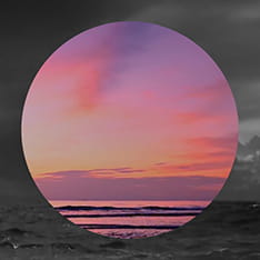 Circular cropped image of a calm ocean on top of a stormy ocean