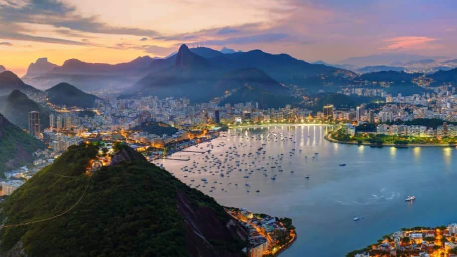 Image of a bay and city surrounded by mountains