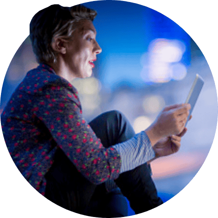 Woman sitting down looking at tablet device