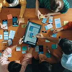 Aerial view of a group of people looking at a tablet