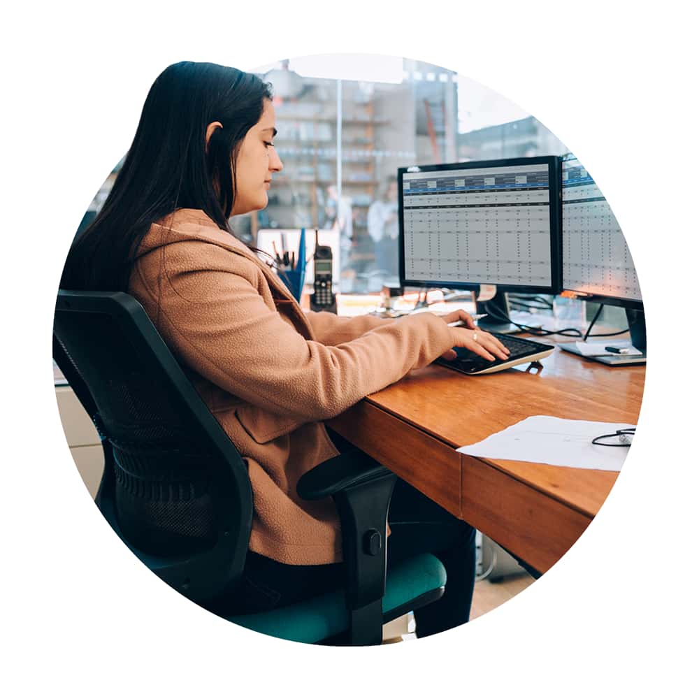 View of office worker using desktop computer