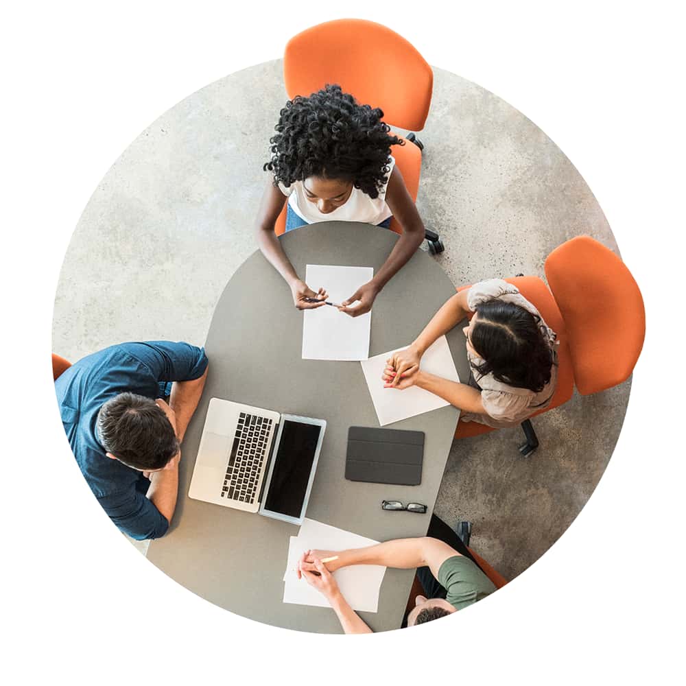 Overhead view of people meeting around a table