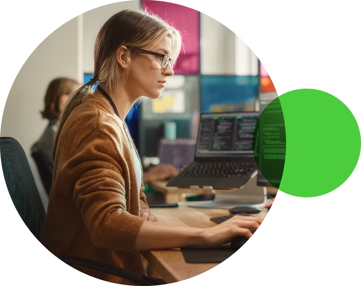 Woman wearing glasses coding in her computer