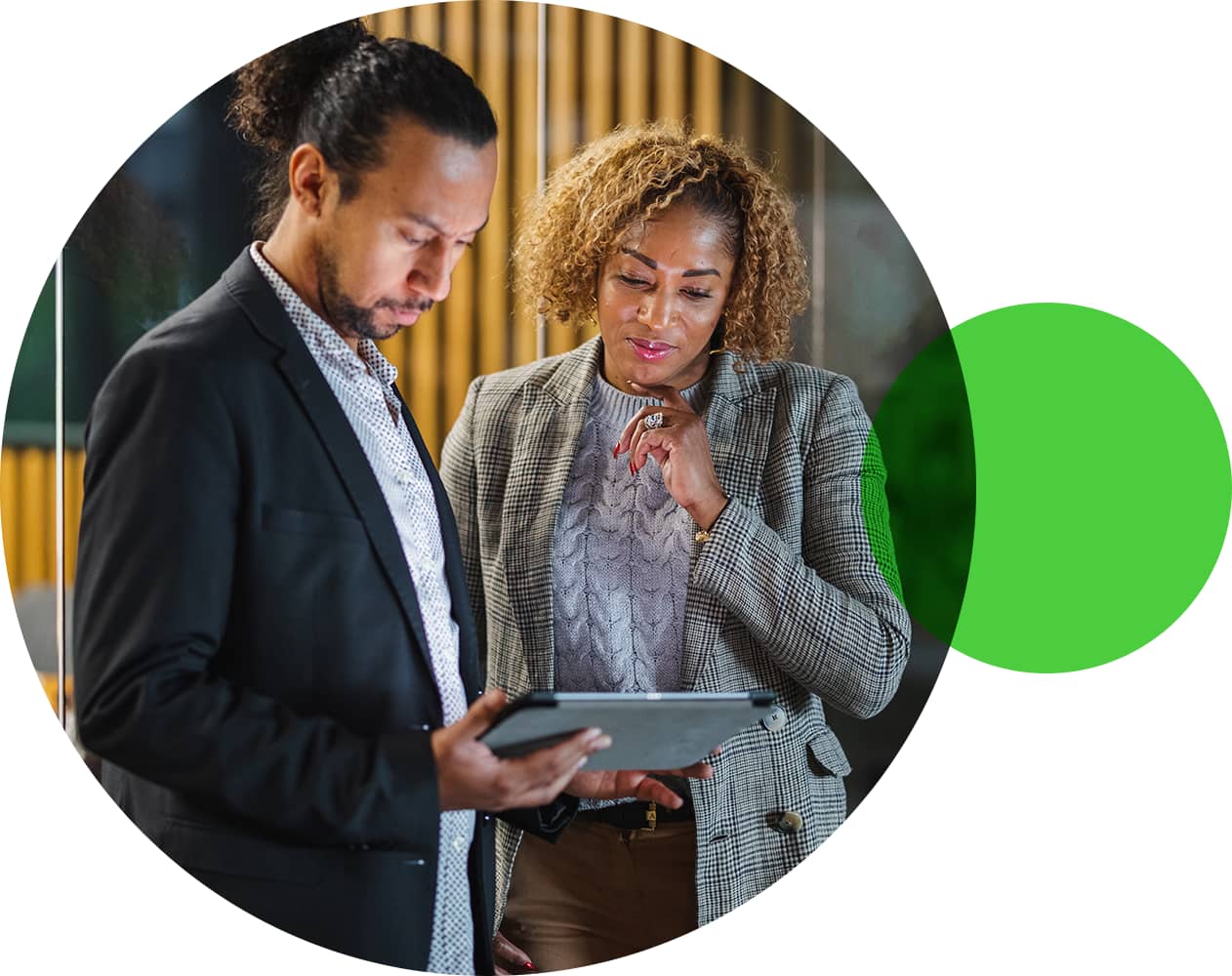 Two office colleagues looking at tablet device