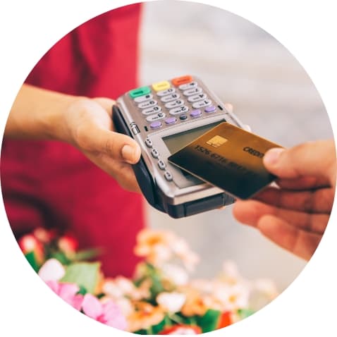 Closeup of hand scanning credit card over payment terminal