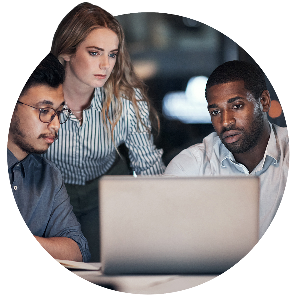 Three persons in front of a laptop computer